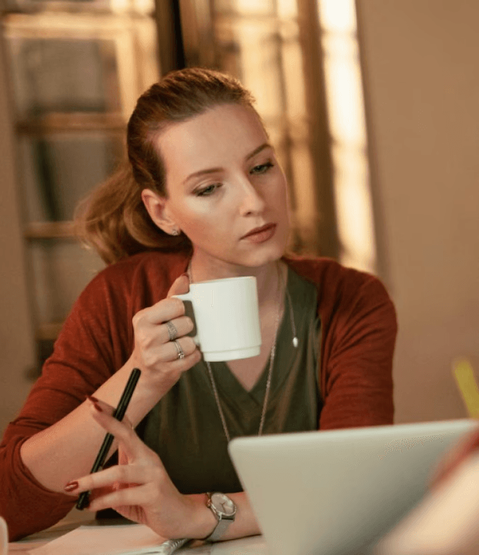 Professional reviewing work at laptop